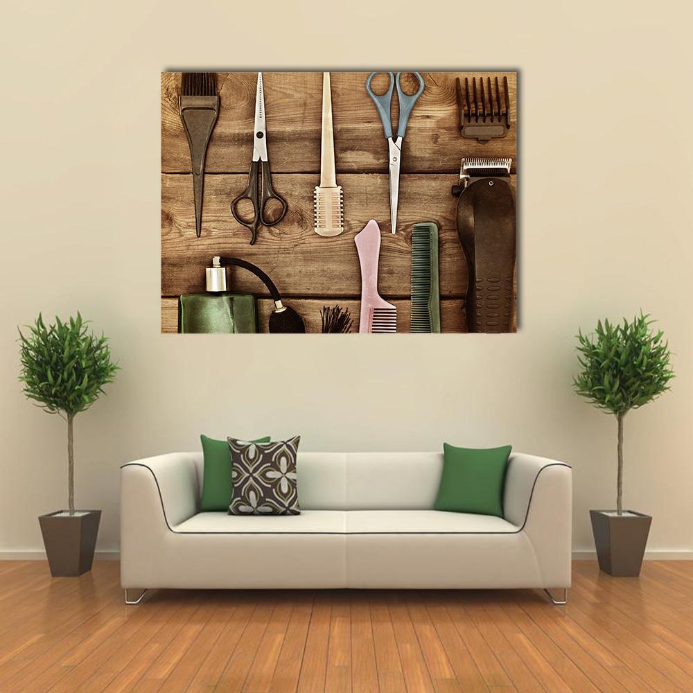 Vintage Hairdressing Tools on Wood Canvas Wall Art in black and brown, single panel hung on a wall