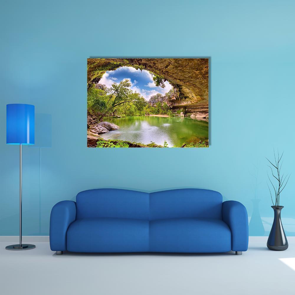 Hamilton Pool Cave Opening Canvas Wall Art in brown, green and blue, single panel hung on a wall
