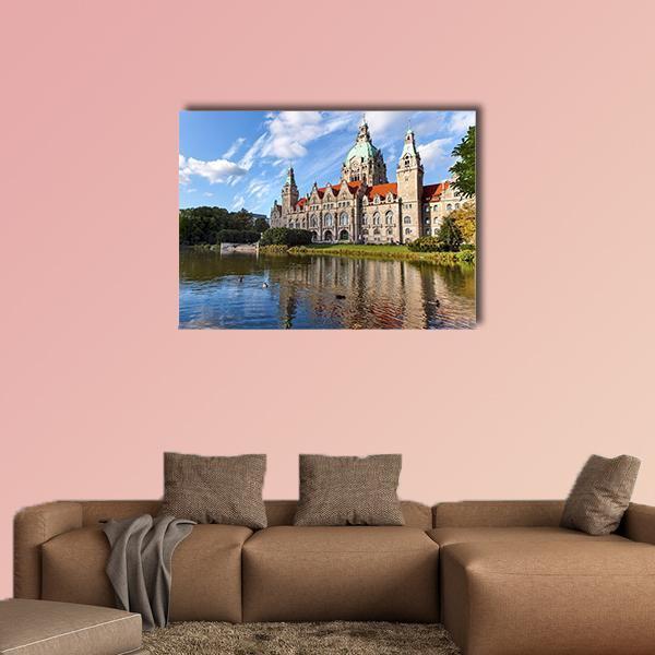 Hanover City Hall with Lake Reflection Canvas Wall Art in brown, green and blue, single panel hung on a wall