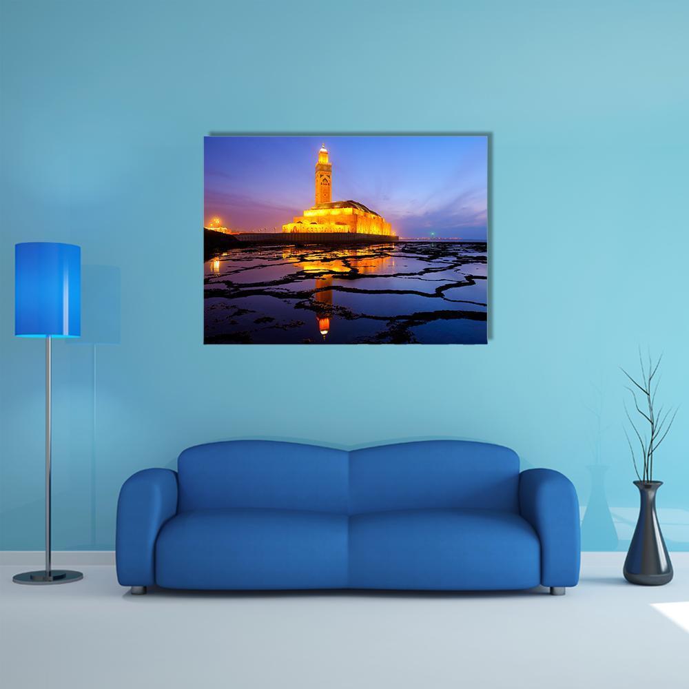 Hassan Ii Mosque at Night Canvas Wall Art in gold, yellow and blue, single panel hung on a wall