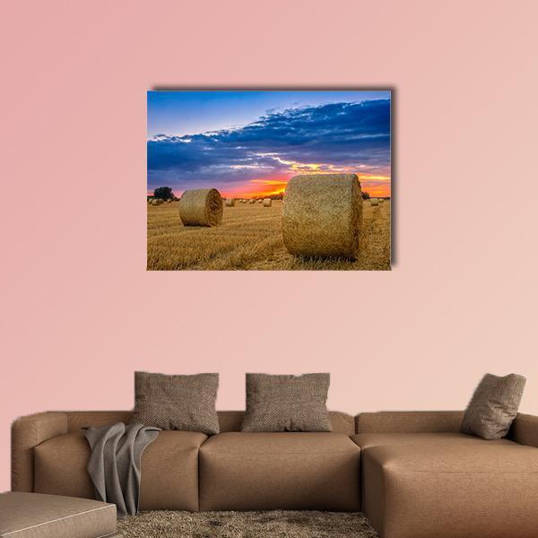 Golden Hay Bales at Sunset Canvas Wall Art in brown, gold and blue, single panel hung on a wall