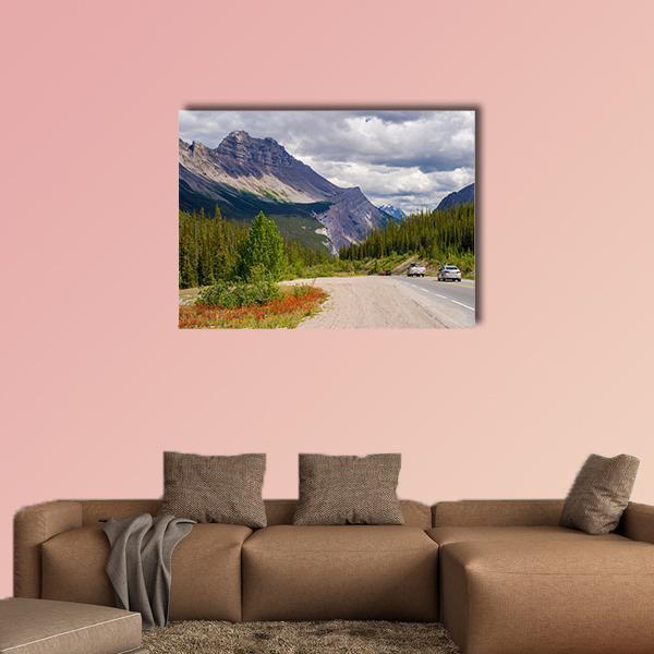 Mountain Road with Red Wildflowers Canvas Wall Art in gray, brown and green, single panel hung on a wall