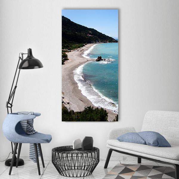 Heart-shaped Beach and Sea Vertical Canvas Wall Art in beige, green and blue, single vertical panel hung on a wall