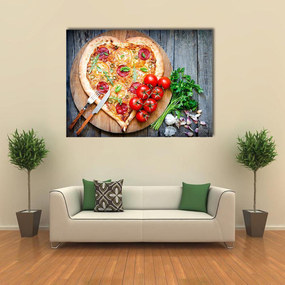 Heart-shaped Pepperoni Pizza Canvas Wall Art in brown, red and yellow, single panel hung on a wall