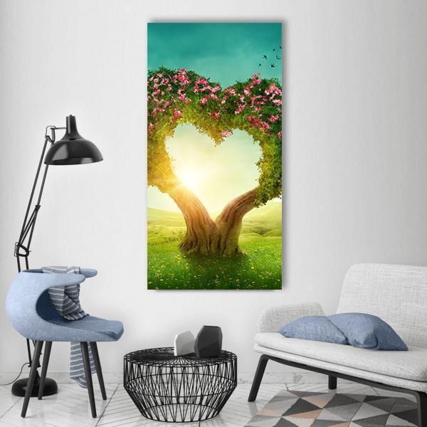 Heart-shaped Tree in Meadow Vertical Canvas Wall Art in yellow, green and pink, single vertical panel hung on a wall