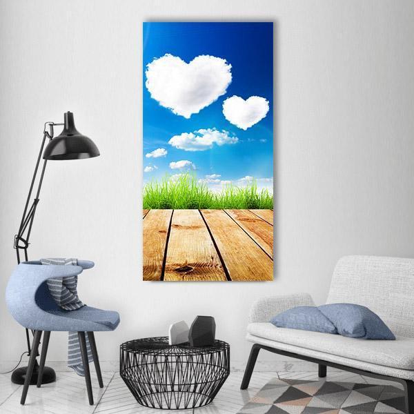 Heart-shaped Clouds Above Wooden Deck Vertical Canvas Wall Art in white, brown and blue, single vertical panel hung on a wall