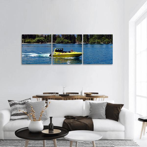 Yellow Jet Boat on Lake Panoramic Canvas Wall Art in yellow, green and blue, hung on a wall
