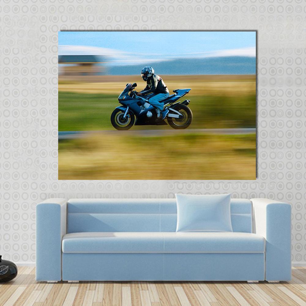 High Speed Motorbike Canvas Wall Art in black, yellow and blue, single panel hung on a wall
