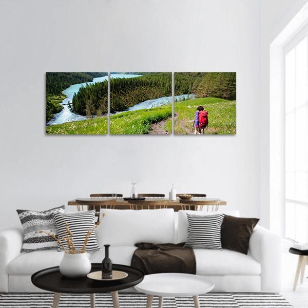 Hiker in Altai Mountains Panoramic Canvas Wall Art in white, green and blue, hung on a wall