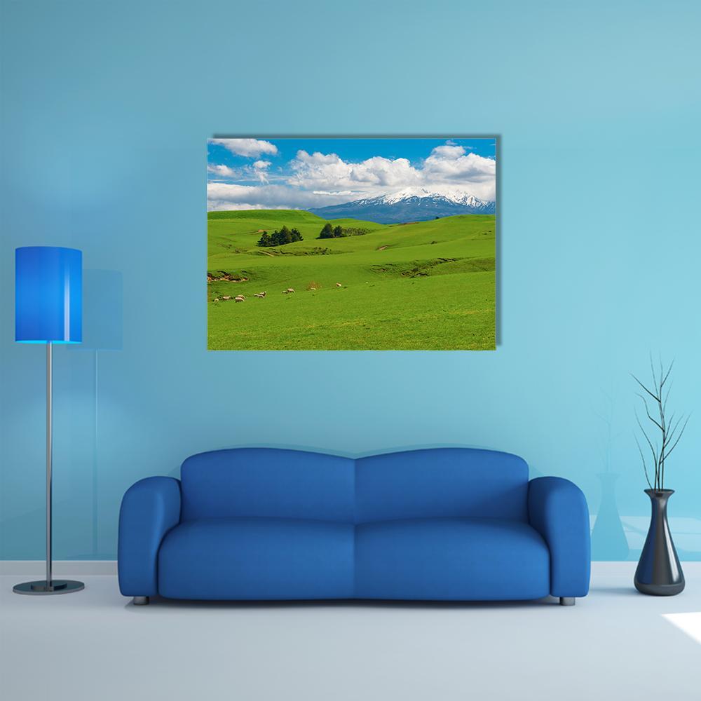 Rolling Green Hills with Grazing Sheep Canvas Wall Art in white, green and blue, single panel hung on a wall