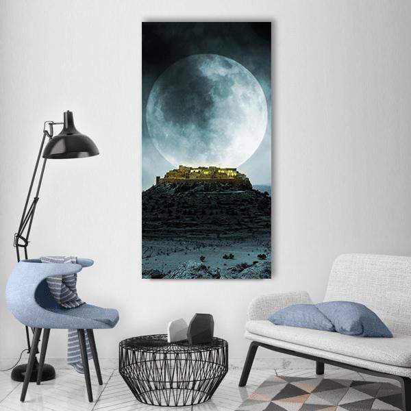 Moonlit Hilltop Village Vertical Canvas Wall Art in black, gray and blue, single vertical panel hung on a wall