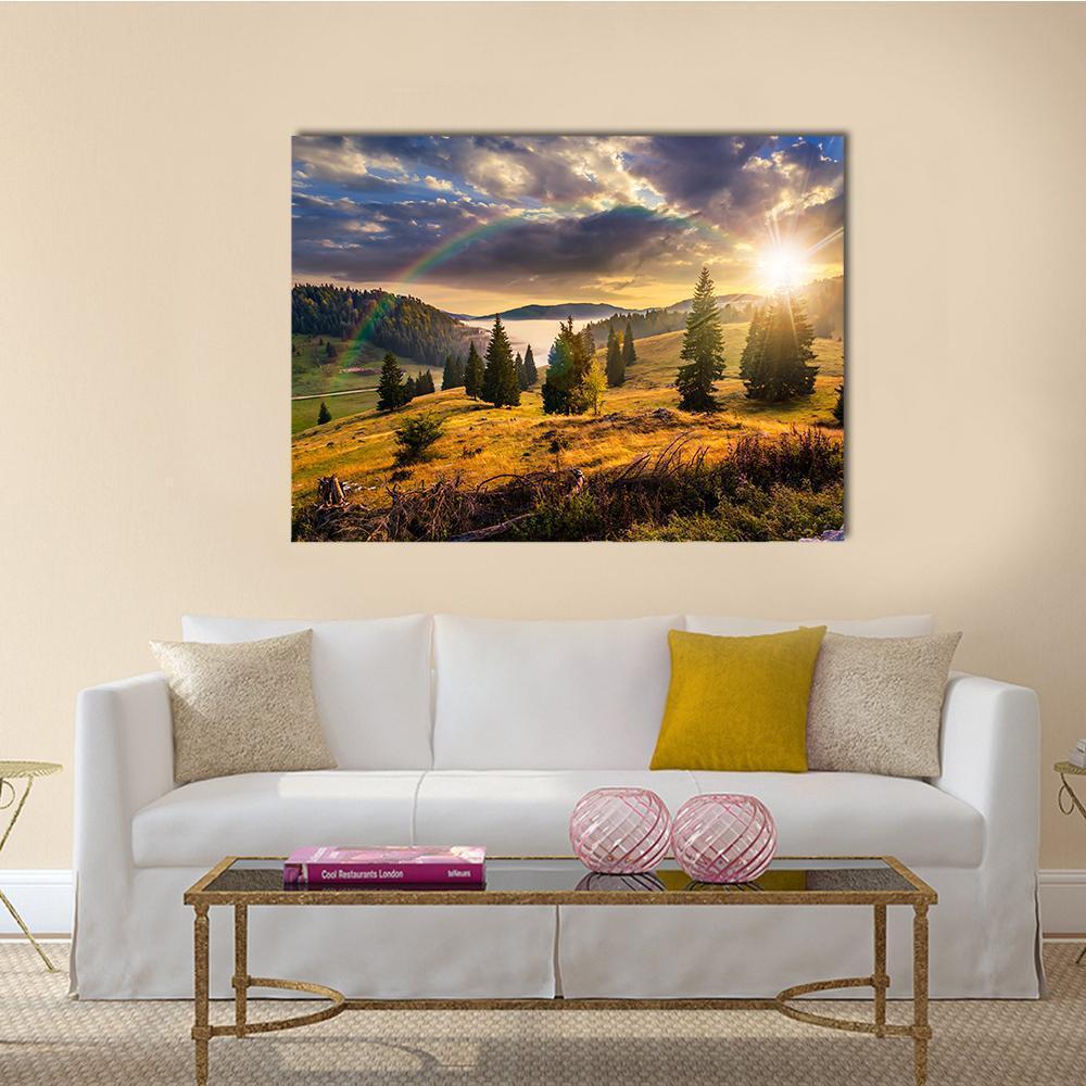 Hillside with Coniferous Forest and Rainbow Canvas Wall Art in yellow, green and blue, single panel hung on a wall