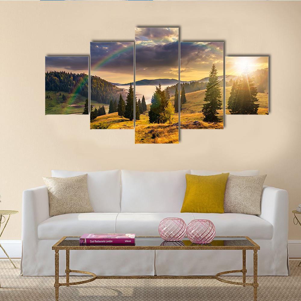 Hillside with Coniferous Forest and Rainbow Canvas Wall Art in yellow, green and blue, 5 panel Star layout hung on a wall