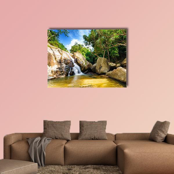 Hin Lad Waterfall Canvas Wall Art in brown, green and blue, single panel hung on a wall