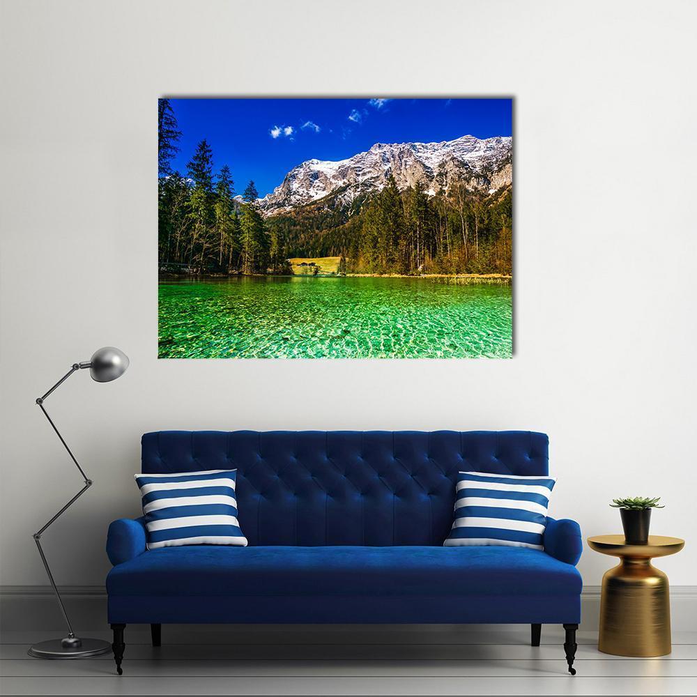 Alpine Lake with Snow-capped Mountain Canvas Wall Art in white, green and blue, single panel hung on a wall