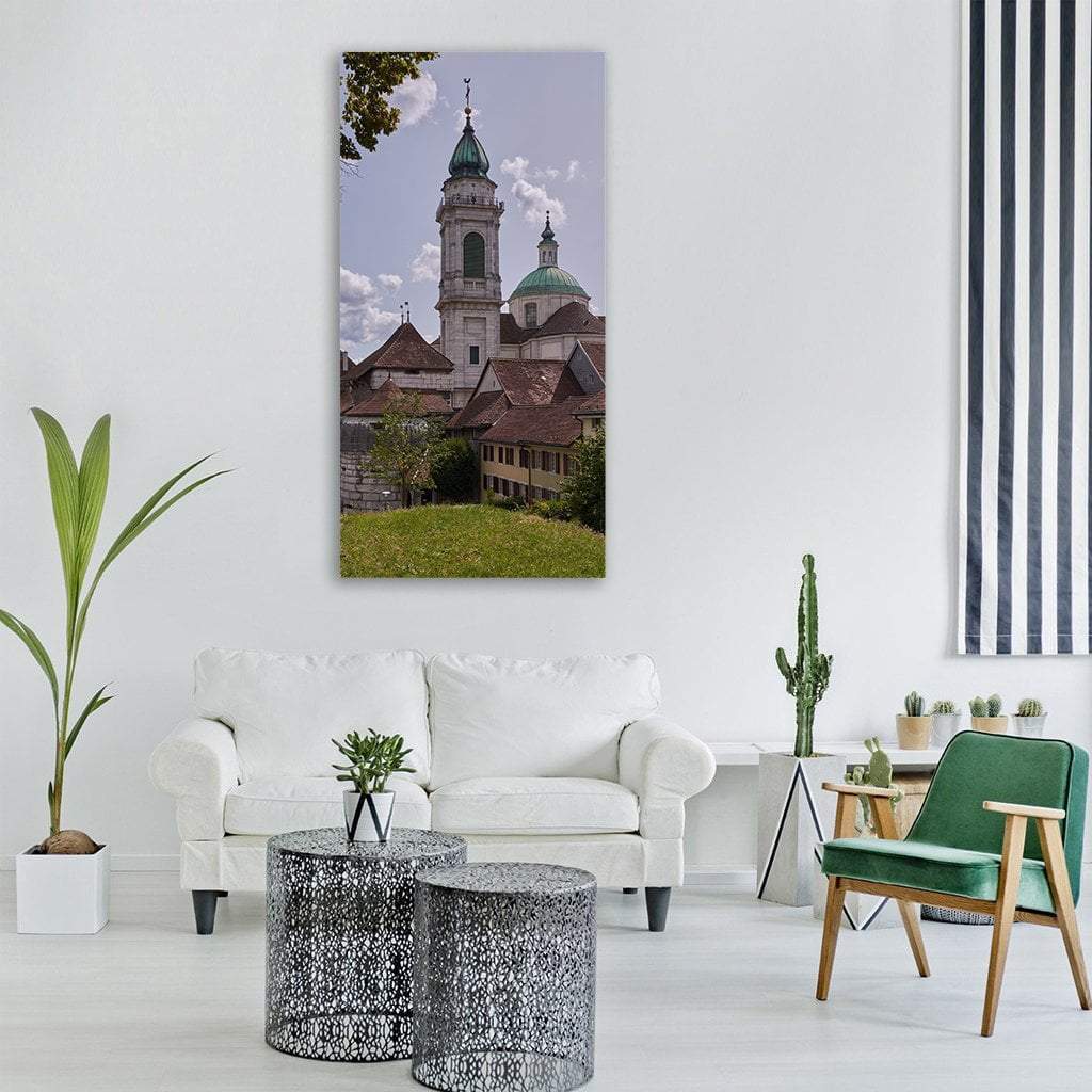 Steeple Church in Switzerland Vertical Canvas Wall Art in gray, brown and green, single vertical panel hung on a wall