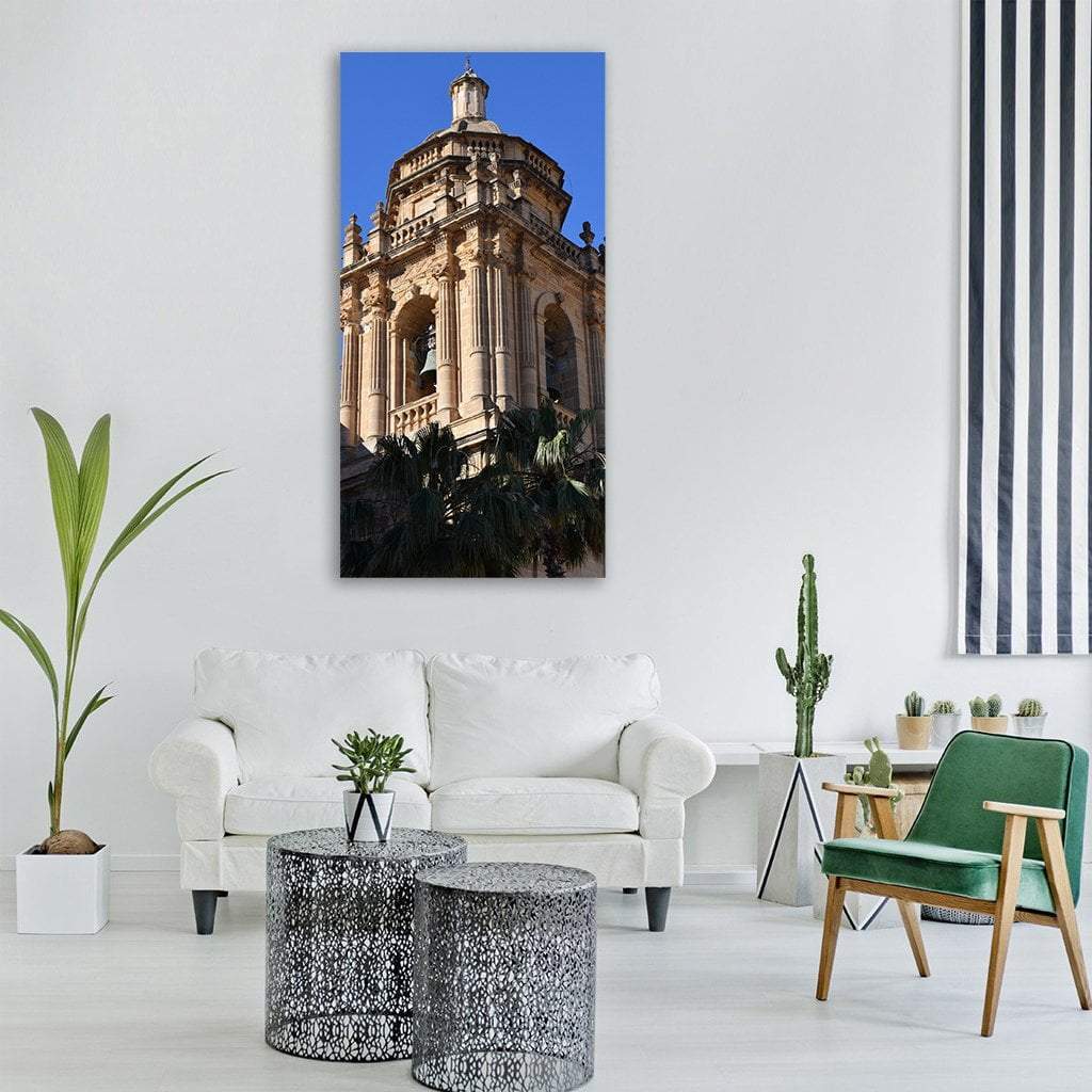 Historic Bell Tower with Palm Trees Vertical Canvas Wall Art in beige, brown and blue, single vertical panel hung on a wall
