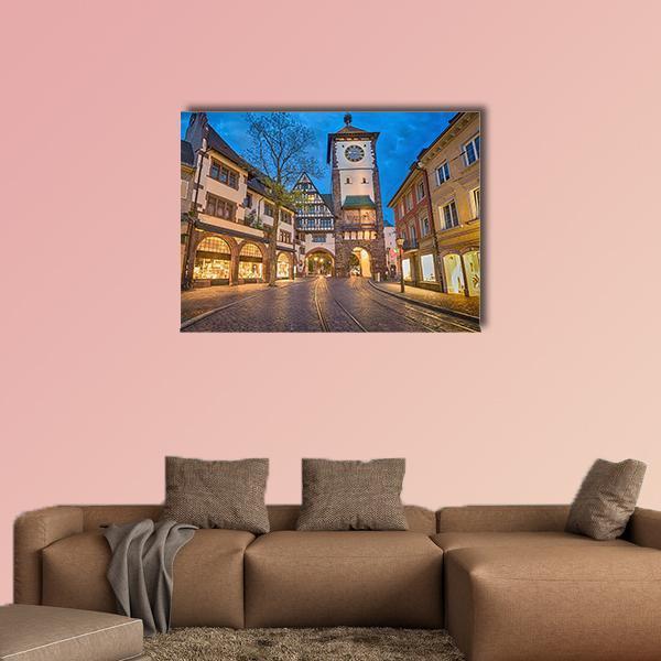 City Gate at Dusk Canvas Wall Art in brown, yellow and blue, single panel hung on a wall