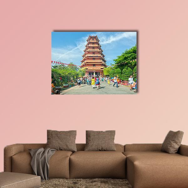 Ho Chi Minh City Pagoda Courtyard Canvas Wall Art in orange, green and blue, single panel hung on a wall