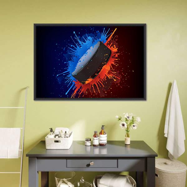 Hockey Puck with Paint Splatter Canvas Wall Art in black, orange and blue, framed canvas, product view on a white background