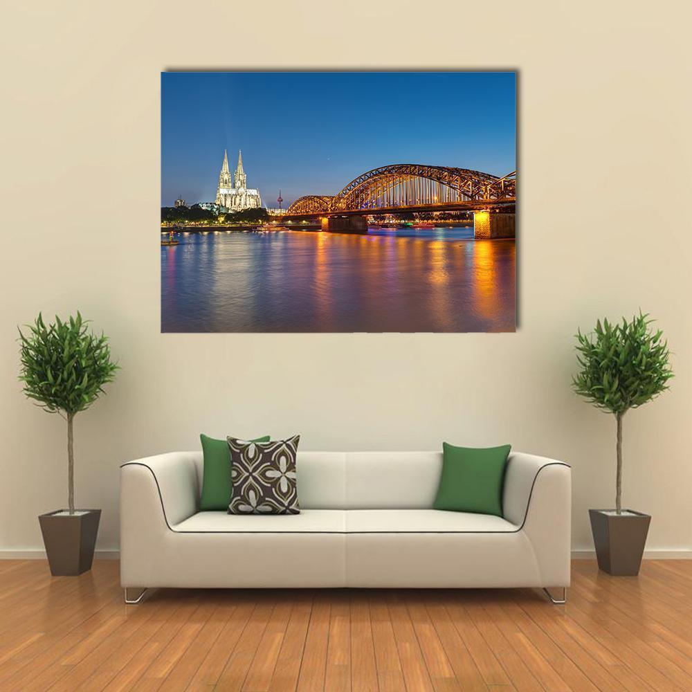Hohenzollern Railway Bridge at Twilight Canvas Wall Art in gold, orange and blue, single panel hung on a wall