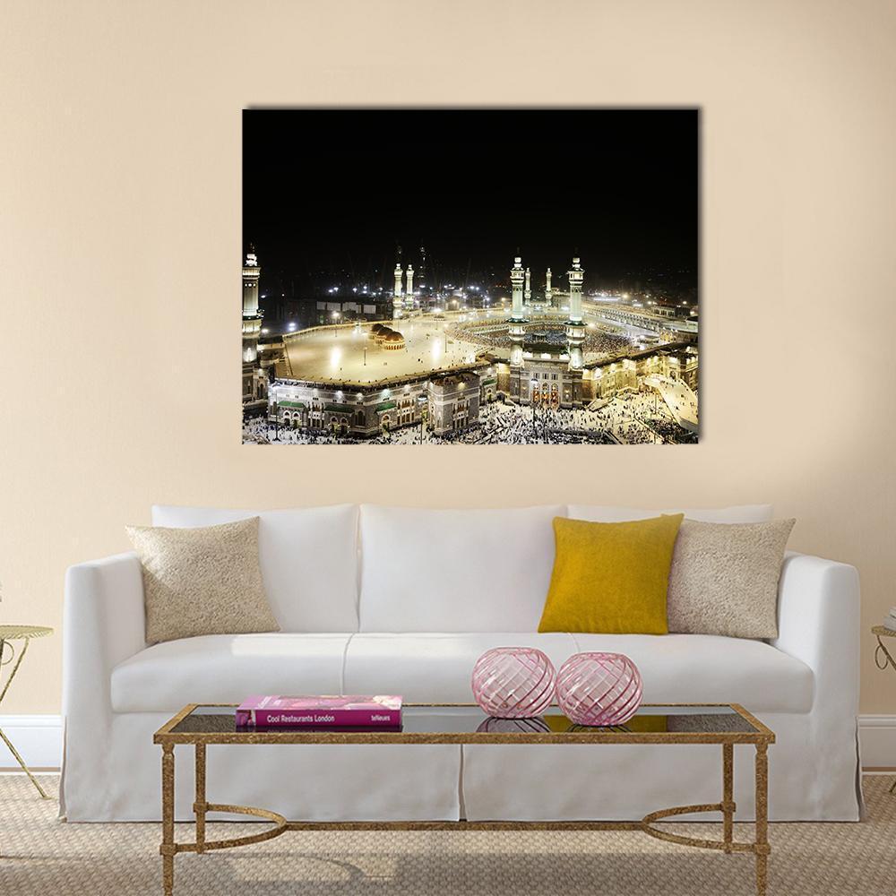 Illuminated Kaaba at Night Canvas Wall Art in black, gold and yellow, single panel hung on a wall