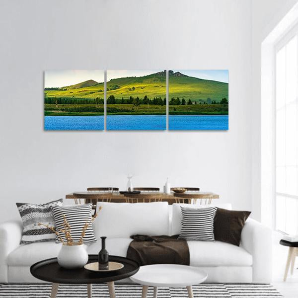 Hongsong Lake with Rolling Green Hills Panoramic Canvas Wall Art in green and blue, hung on a wall