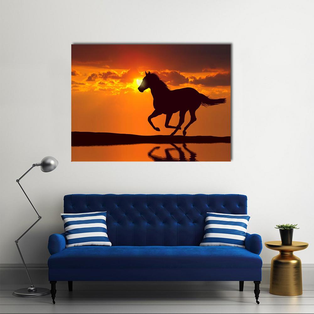 Galloping Horse Silhouette at Sunset Canvas Wall Art in black, orange and yellow, single panel hung on a wall