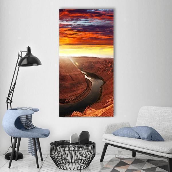 Horseshoe Bend at Sunset Vertical Canvas Wall Art in brown, red and orange, single vertical panel hung on a wall