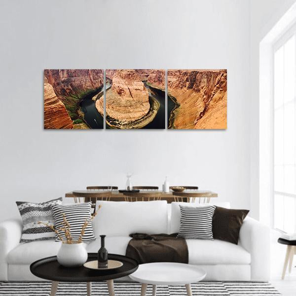 Horseshoe Bend in Arizona Panoramic Canvas Wall Art in brown, orange and blue, hung on a wall