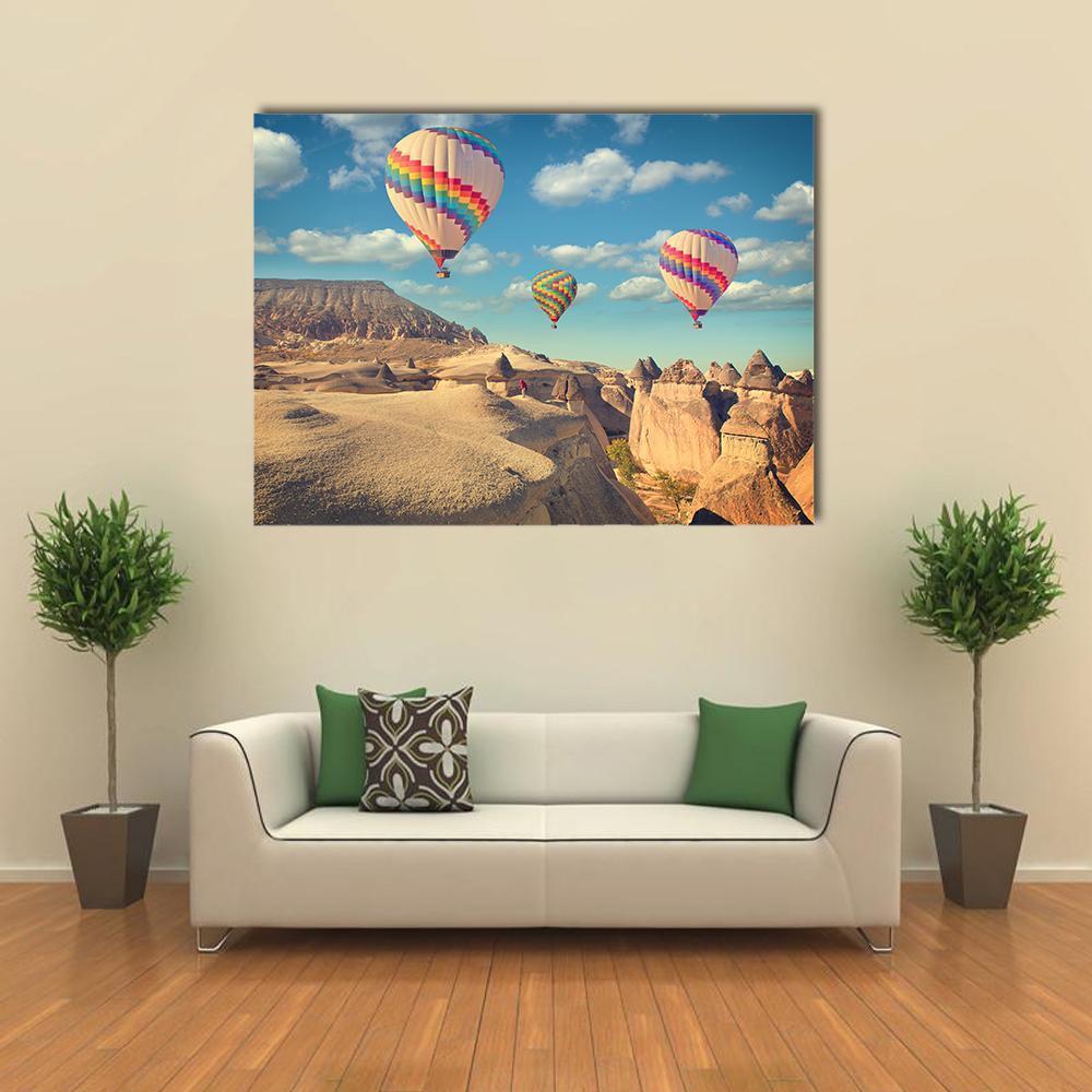 Hot Air Balloons Over Cappadocia Canvas Wall Art in beige, brown and blue, single panel hung on a wall
