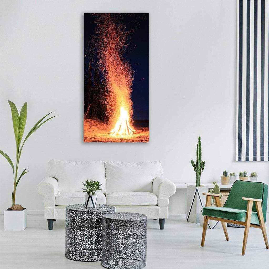 Teepee Bonfire on Winter Beach Vertical Canvas Wall Art in black, orange and yellow, single vertical panel hung on a wall