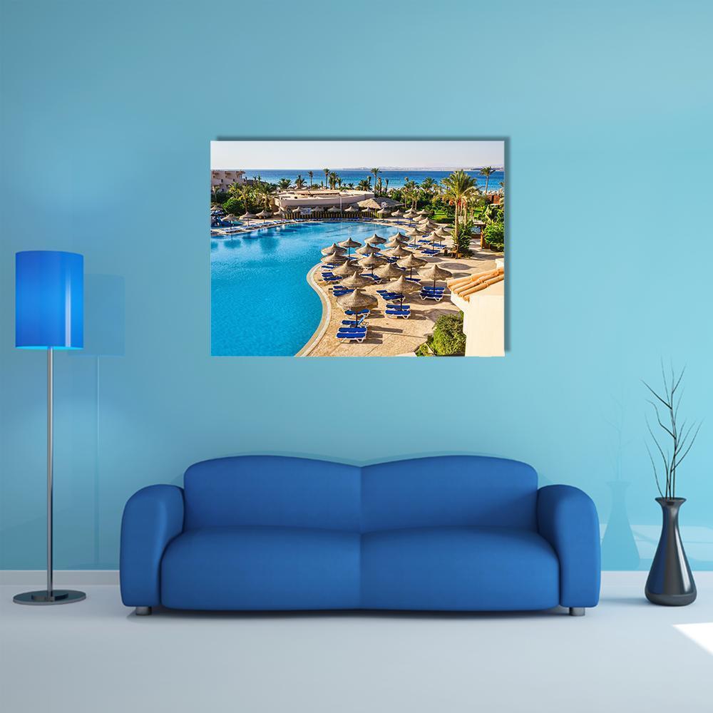 Aerial View of Hotel Pool in Egypt Canvas Wall Art in beige, green and blue, single panel hung on a wall