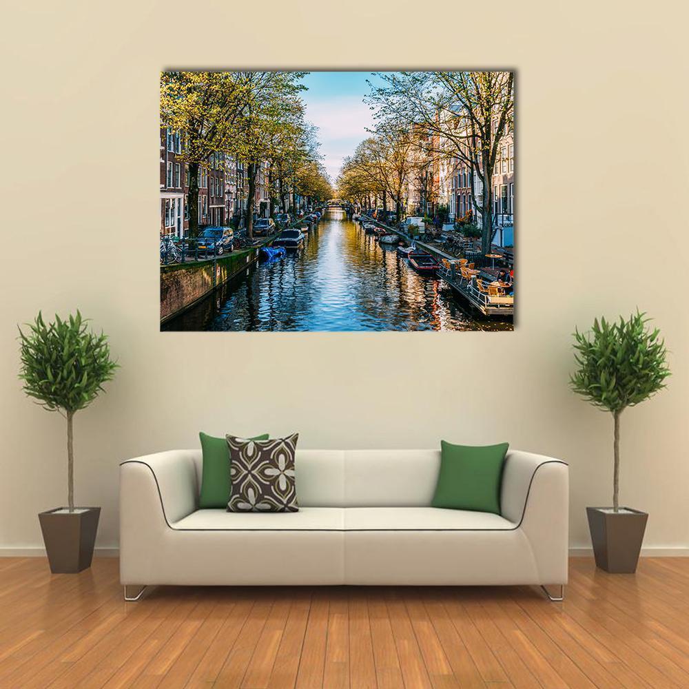 Houseboats on an Amsterdam Canal Canvas Wall Art in brown, green and blue, single panel hung on a wall