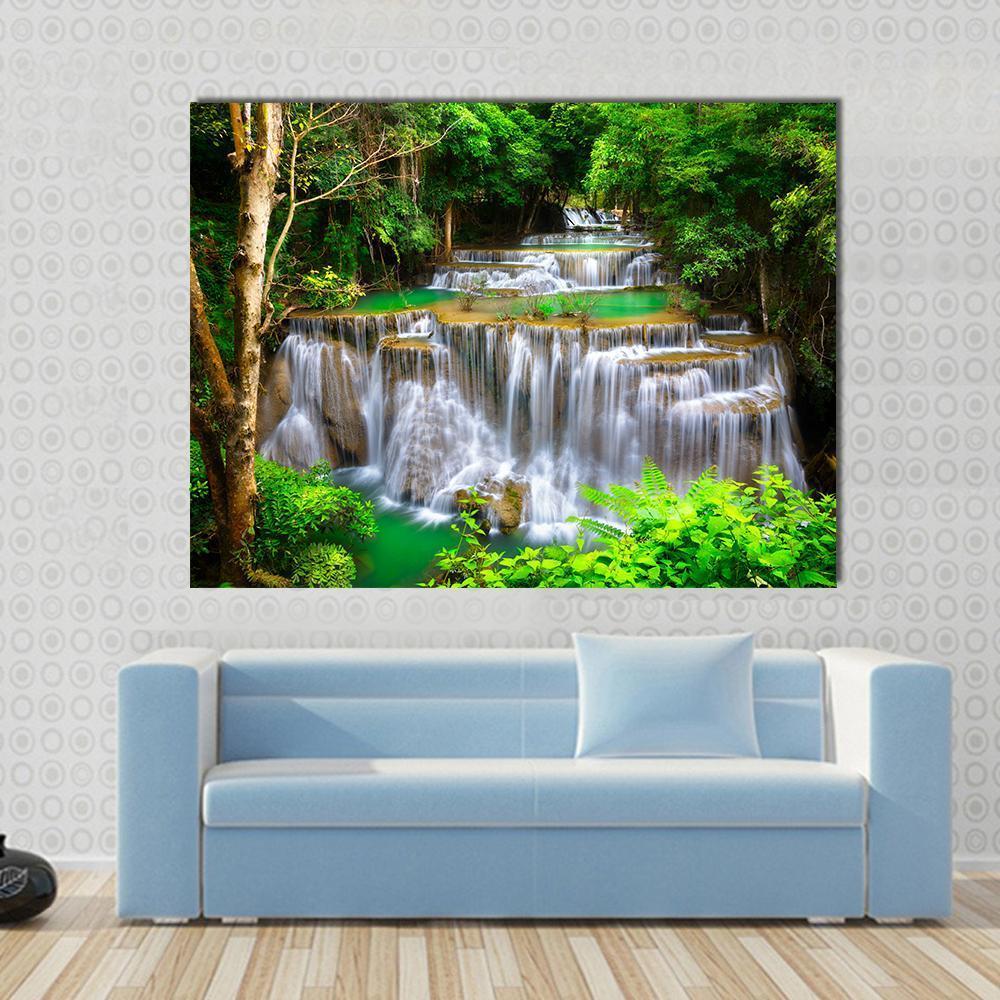 Huay Mae Kamin Waterfall Canvas Wall Art in white, brown and green, single panel hung on a wall