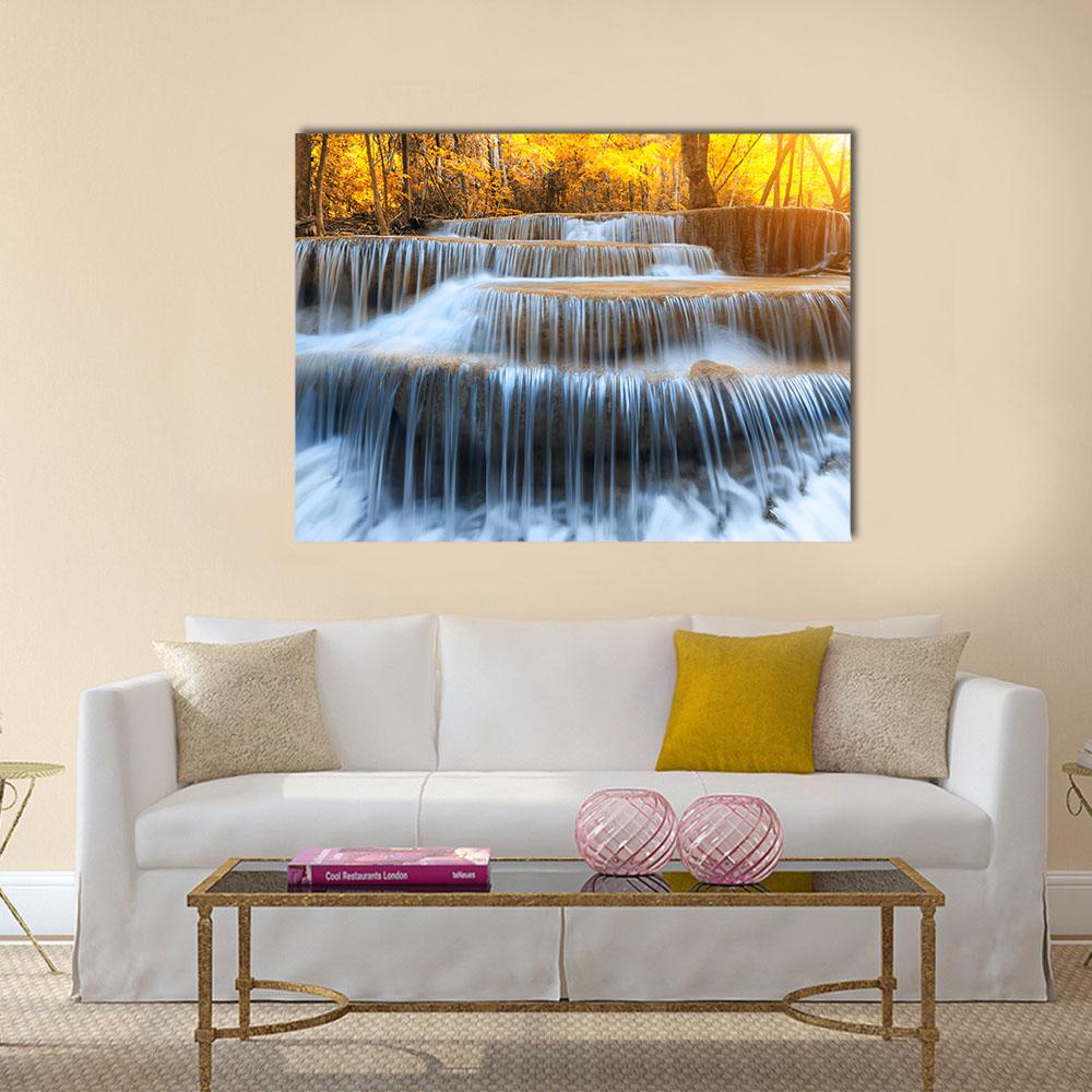 Waterfall in Yellow Forest Canvas Wall Art in white, yellow and blue, single panel hung on a wall