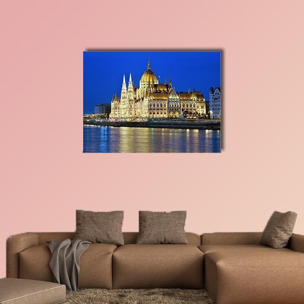 Hungarian Parliament at Night Canvas Wall Art in gold, yellow and blue, single panel hung on a wall