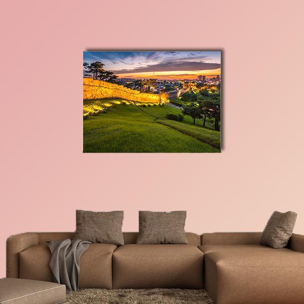 Hwaseong Fortress at Sunset Canvas Wall Art in orange, green and blue, single panel hung on a wall