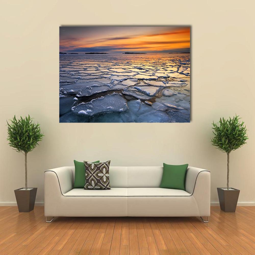 Sunset Over Sea Ice Floes Canvas Wall Art in gray, orange and blue, single panel hung on a wall