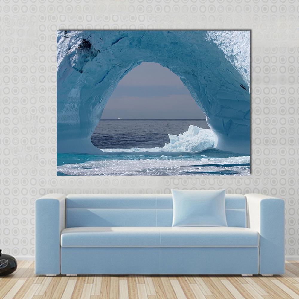Iceberg Arch in the Atlantic Ocean Canvas Wall Art in white and blue, single panel hung on a wall