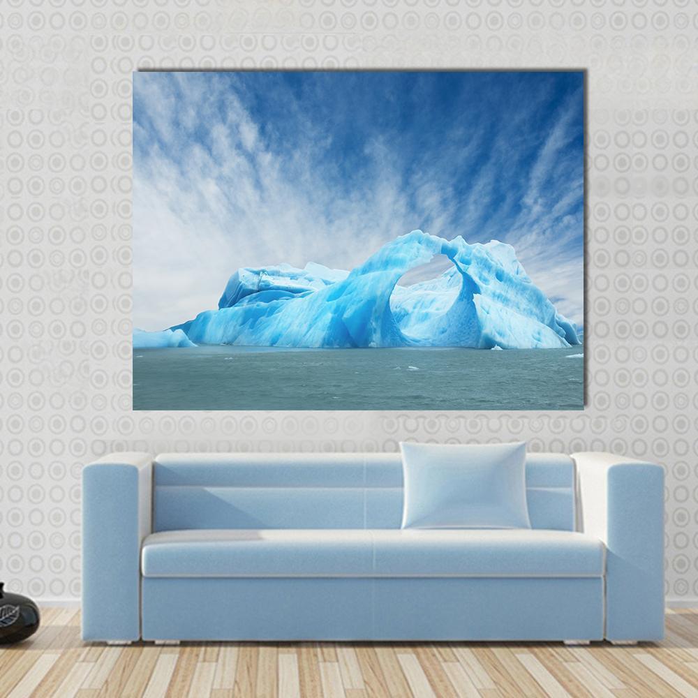 Iceberg Floating in the Water Canvas Wall Art in white and blue, single panel hung on a wall