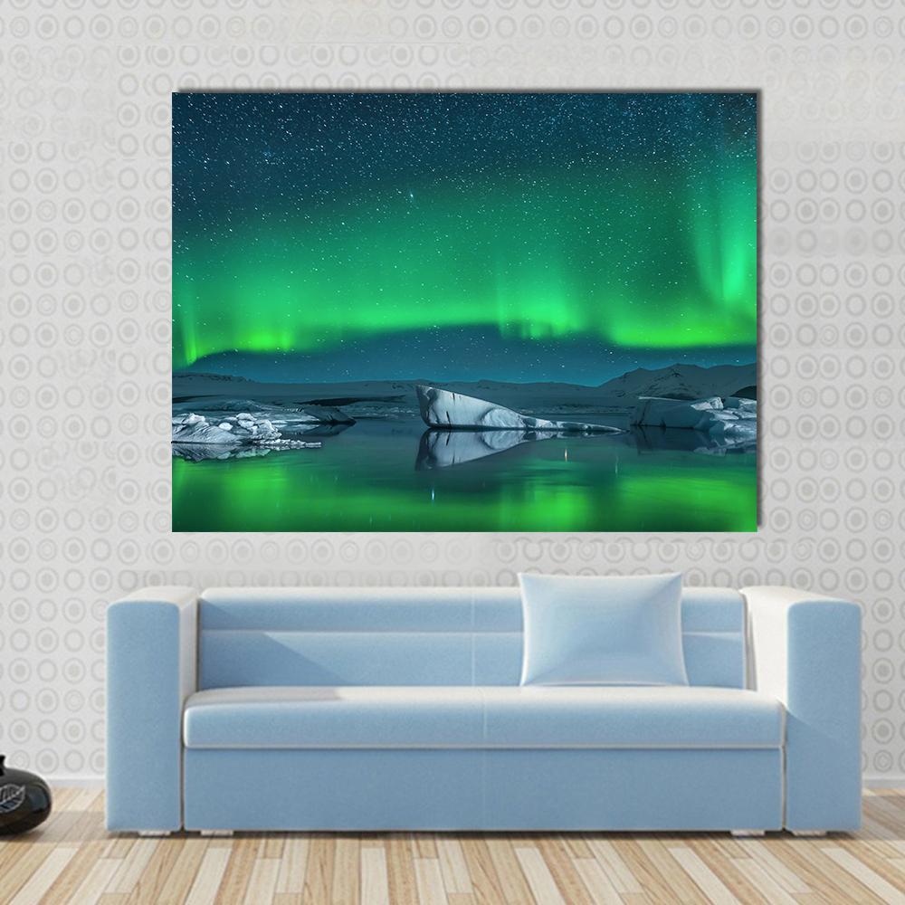Icebergs Under Northern Lights Canvas Wall Art in green, blue and navy, 5 panel Star layout hung on a wall