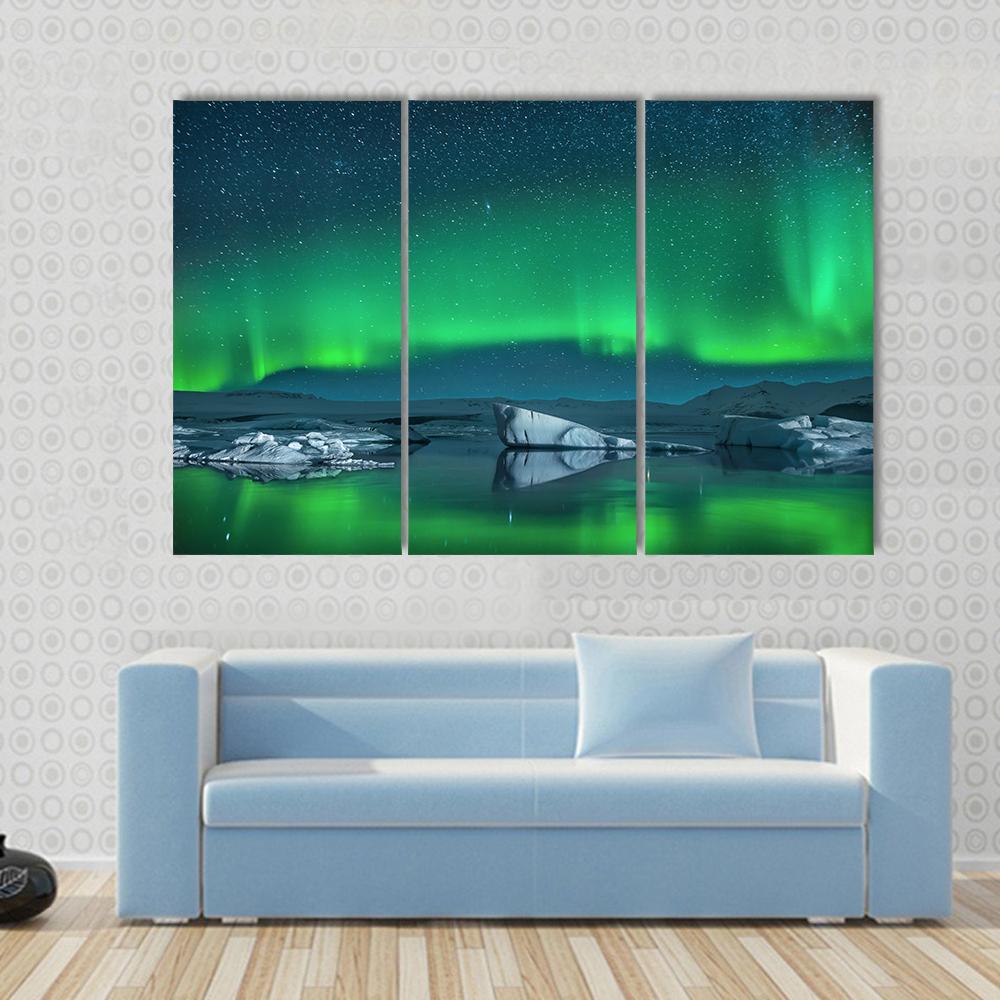 Icebergs Under Northern Lights Canvas Wall Art in green, blue and navy, 5 panel Star layout hung on a wall