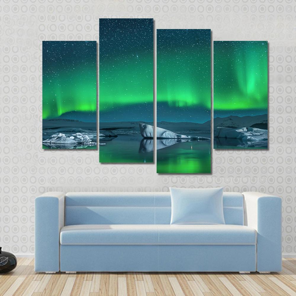 Icebergs Under Northern Lights Canvas Wall Art in green, blue and navy, 5 panel Star layout hung on a wall