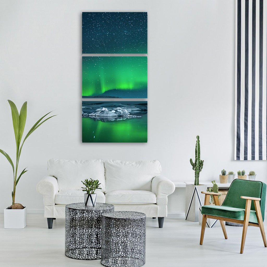 Icebergs Under Northern Lights Vertical Canvas Wall Art in black, green and blue, single vertical panel hung on a wall
