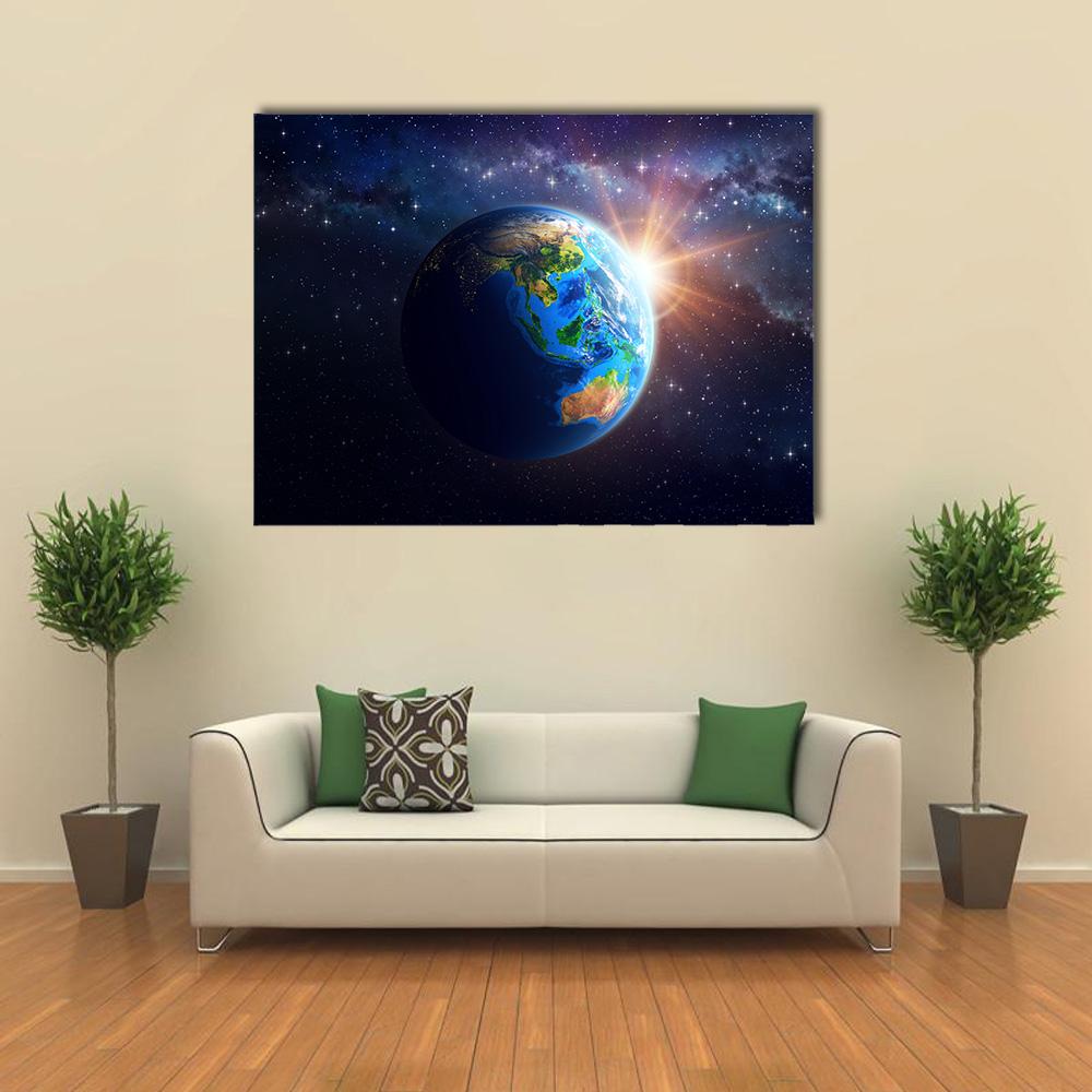 Earth Sunrise Over Asia and Australia Canvas Wall Art in black and blue, single panel hung on a wall
