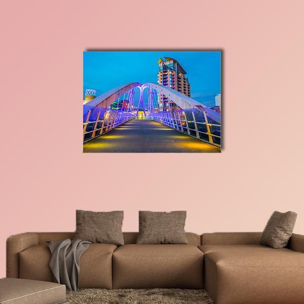 Illuminated Footbridge in Salford Canvas Wall Art in yellow, blue and purple, single panel hung on a wall