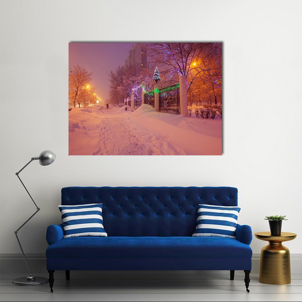 Snowy Night Path with Christmas Lights Canvas Wall Art in white, orange and purple, single panel hung on a wall