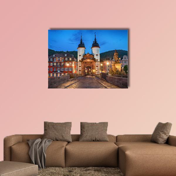 Illuminated Old Bridge Gate Canvas Wall Art in brown, orange and blue, single panel hung on a wall