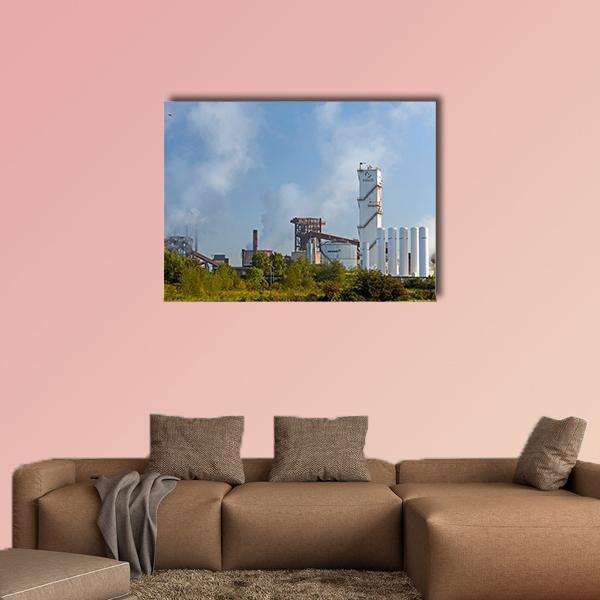 German Steel Plant with White Tanks Canvas Wall Art in white, gray and blue, single panel hung on a wall